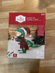 Light-up Plush T-rex Christmas Yard Decoration Holiday Time 24 Long 1.5 Tall. Fixed Price $30.00.