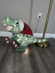 Light-up Plush T-rex Christmas Yard Decoration Holiday Time 24 Long 18" Tall. Fixed Price $50.00.