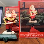 Two - Potpourri 1992 Christmas Stocking Hangers Holder Santa Peace Cast Iron. Fixed Price $22.00.
