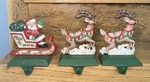 3 Vtg Cast Iron Midwest Importers Christmas Stocking Hangers Santa & Reindeer. Fixed Price $120.00.