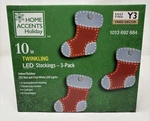 Home Accents 10 Inch 3-PACK Twinkling Led Stockings Christmas Decoration. Fixed Price $39.99.
