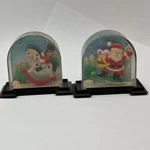 2 Vtg Kurt Adler Plastic Christmas Snow Globe Santa-reindeer Rocking Horse. Fixed Price $30.00.