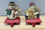 Vtg Set Of 2 Santas Workbench Stocking Holders Snowman Crackled Cast Iron. Fixed Price $32.95.